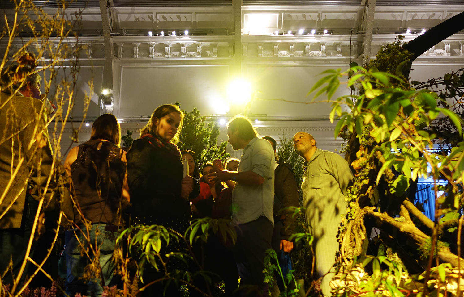 The crowd gathers within the food forest at Lindlay Hall