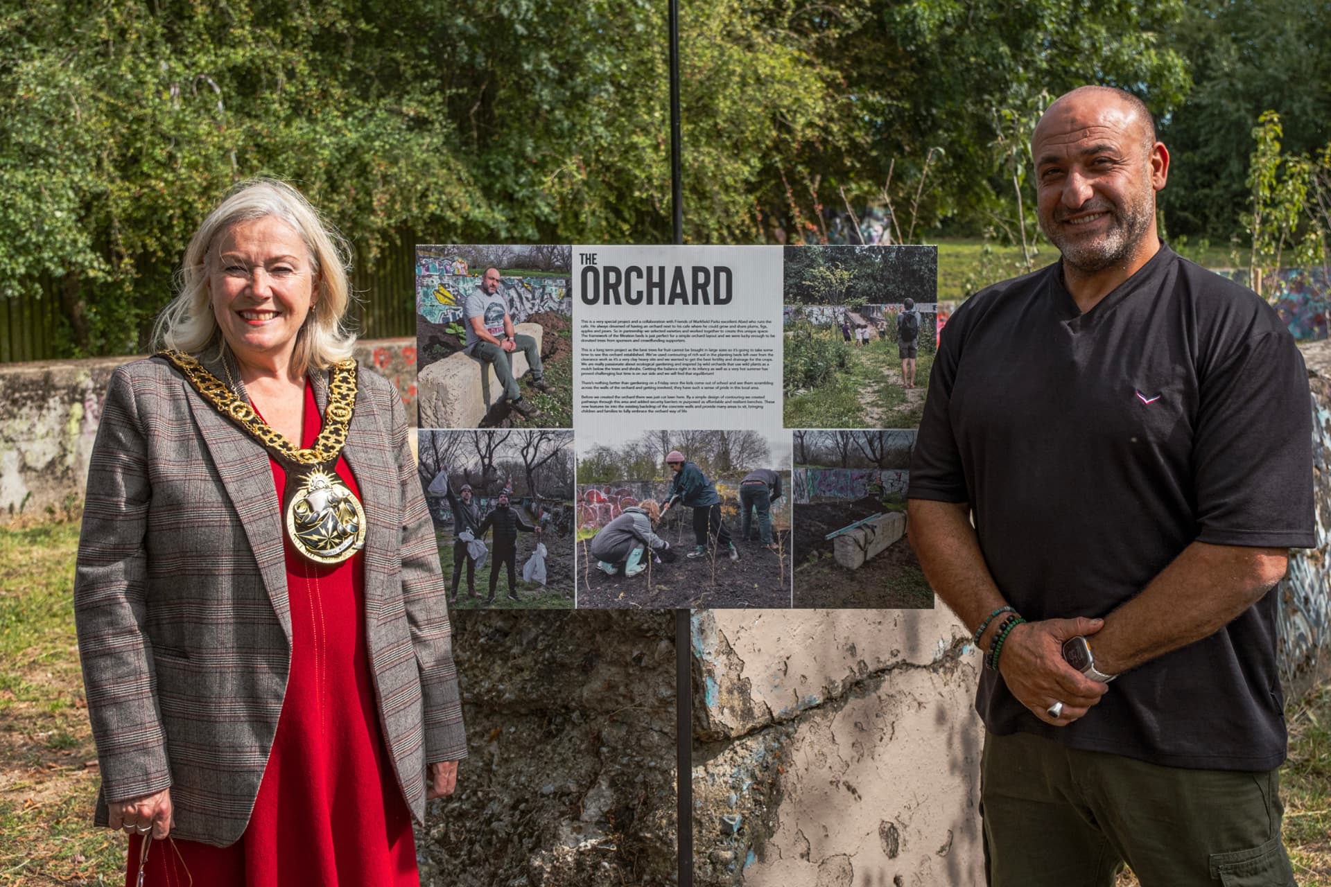 The Mayor of Haringey beside the Orchard information board with a Wild City Studio founder