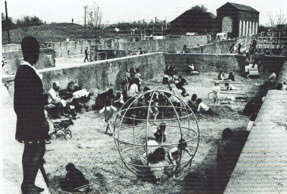 Archive photograph of children playing on a climbing globe in the concrete filtration beds turned meanwhile play space