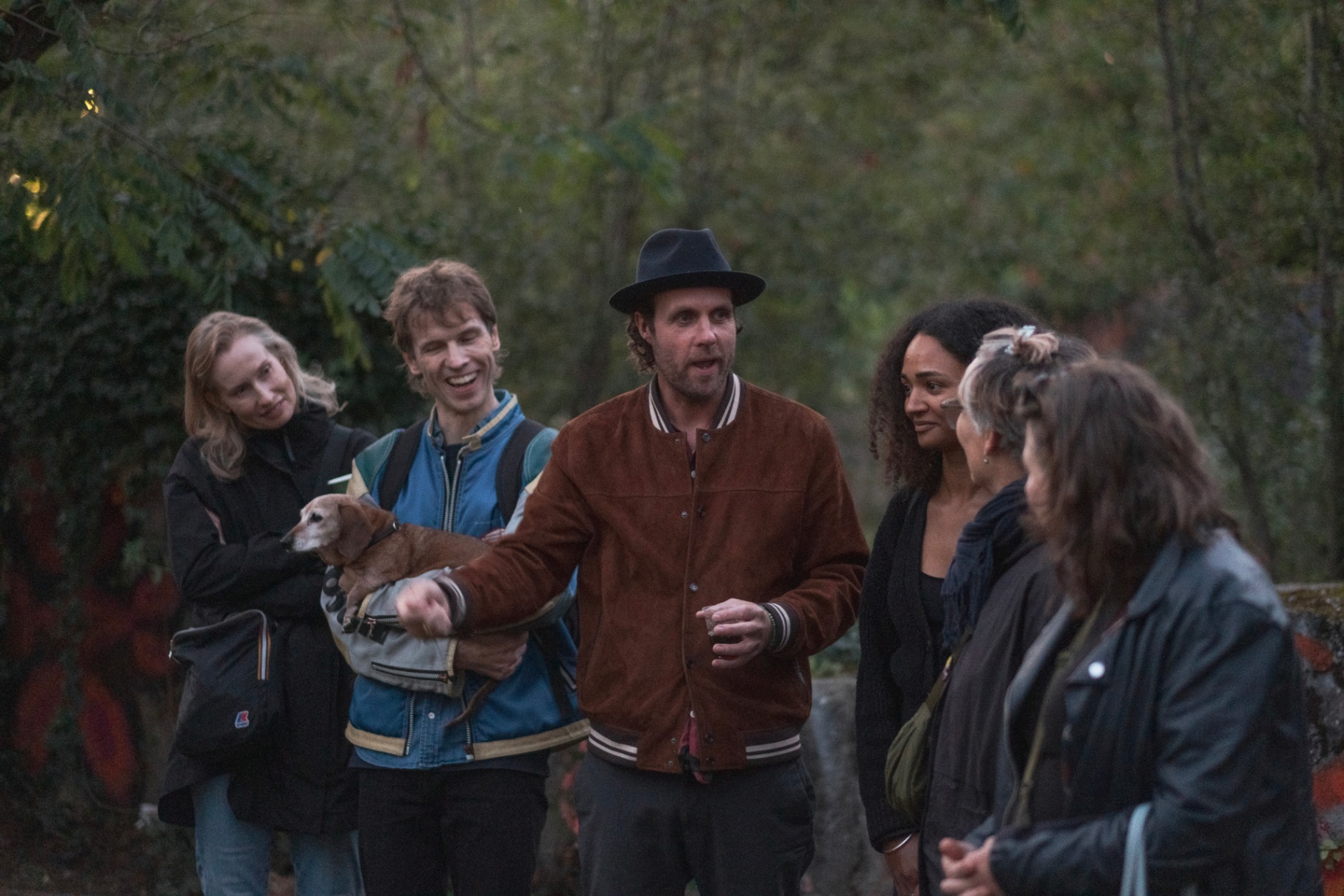 Group laughing together in the garden at dusk.
