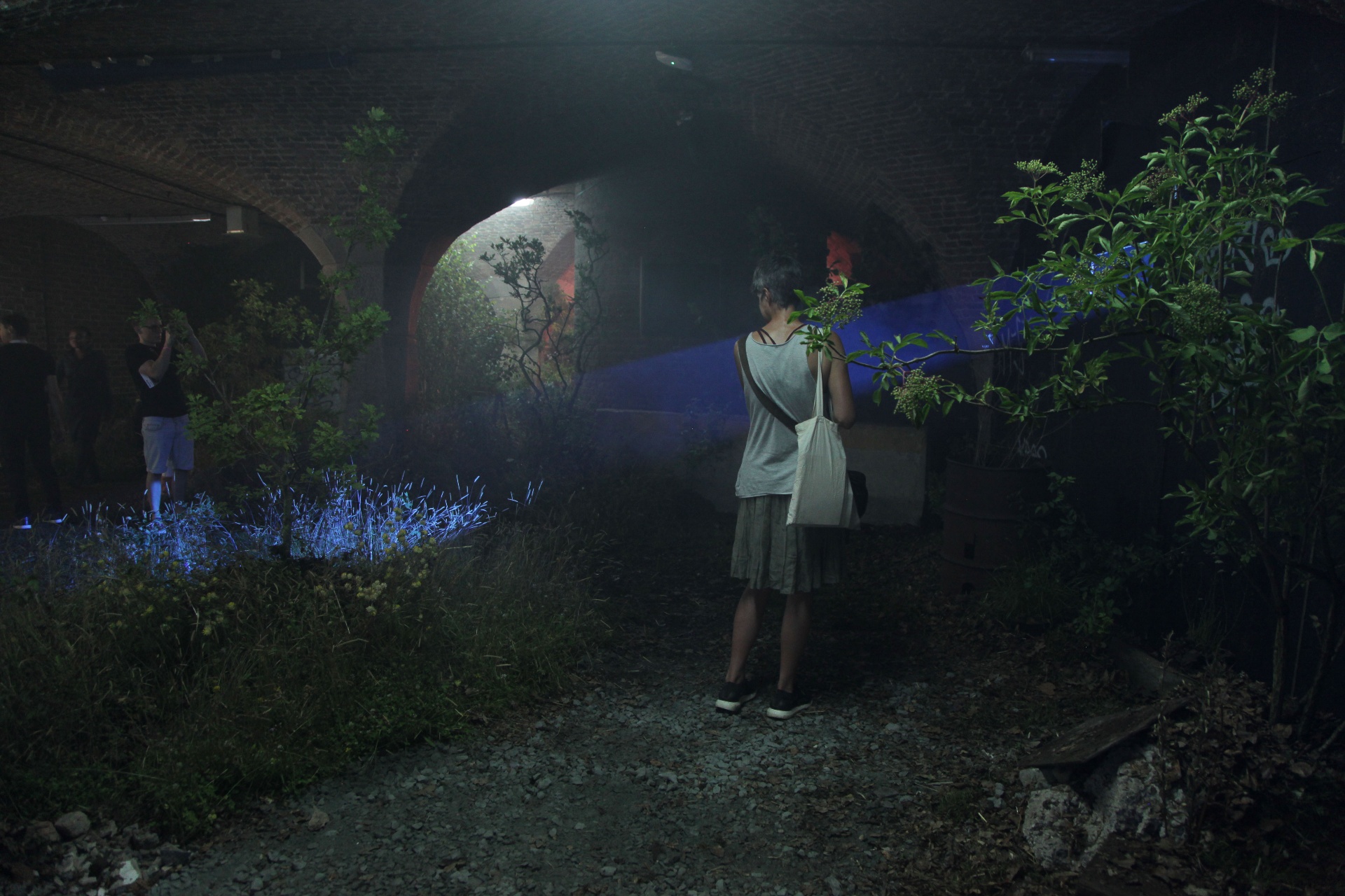 A woman standing in a room with blue light
